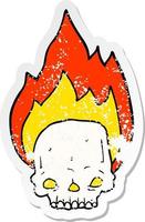 distressed sticker of a spooky cartoon flaming skull