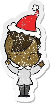 distressed sticker cartoon of a squinting girl wearing santa hat