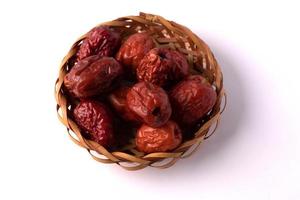 Dried jujube in a plate on a white background photo