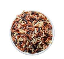 Three colors of brown rice in a ceramic cup on a white background. for eating healthy lifestyle photo