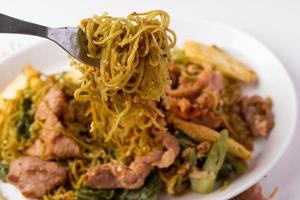 Fried jade noodles with soy sauce and pork photo