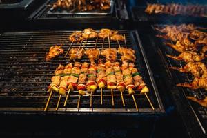 Barbecue skewers on a street side grill photo