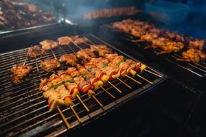 Barbecue skewers on a street side grill photo