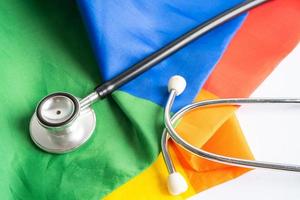 Black stethoscope on rainbow flag background, symbol of LGBT pride month  celebrate annual in June social, symbol of gay, lesbian, bisexual, transgender, human rights and peace. photo