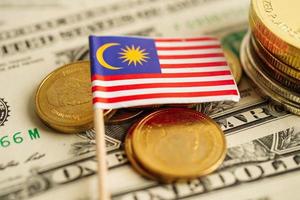 Malaysia flag on coins background, finance and accounting, banking concept. photo