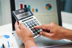 Businessman working and analysis with calculate and statistic graph in office. photo