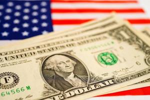 US dollar banknotes money on USA America flag, finance economy concept. photo