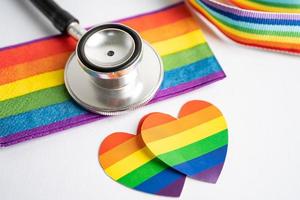 Black stethoscope with rainbow flag heart on white background, symbol of LGBT pride month  celebrate annual in June social, symbol of gay, lesbian, bisexual, transgender, human rights and peace. photo