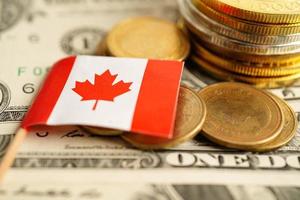 Stack of coins with Canada flag on USA America dollar banknotes. photo