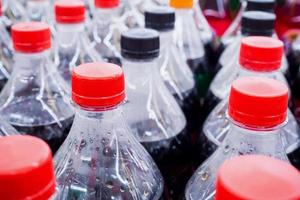 Carbonated soft drink bottles close up photo