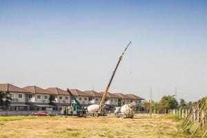 House building at construction site with crane truck photo