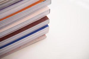 pile of magazines stack on white table in living room photo