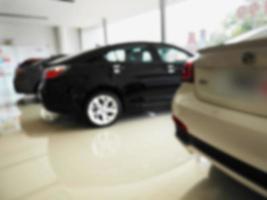 blur photo of new car at car showroom