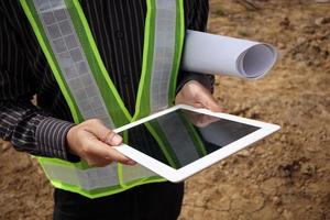 construction engineer worker using tablet computer at building site photo