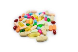 Many colorful pills on white background photo