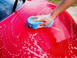 man hand hold sponge for washing car photo