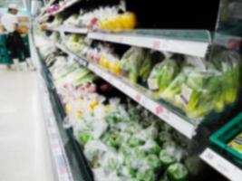 Blur of fresh vegetables on shelf in supermarket photo