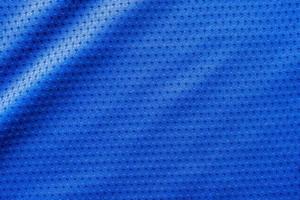 Blue color fabric sport clothing football jersey with air mesh texture background photo