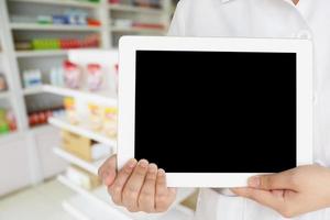pharmacist showing promotion displaying the blank screen of tablet computer photo