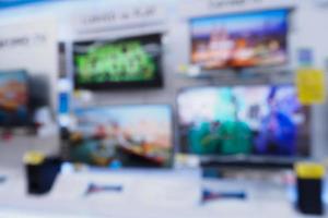 electronic department store with Television on shelves in supermarket blurred bokeh background photo