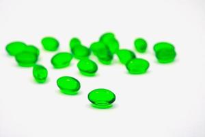 Cápsulas de gelatina blanda de píldoras verdes aisladas sobre fondo blanco foto