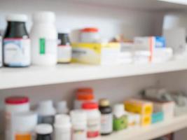 Close up of medicine bottles on shelves of drugs in the pharmacy photo