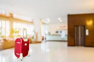 colorful suitcase with hotel lobby photo