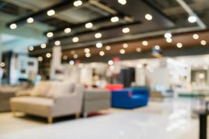 Abstract blur sofa in furniture showroom store interior with bokeh light background for montage product display photo