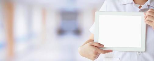 Doctor showing digital tablet with blank screen at the hospital photo