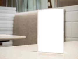 Restaurant table with mock up white sheets paper blank label menu frame acrylic stand photo