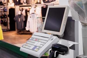 supermarket cash desk checkout counter payment terminal with blank computer monitor screen photo