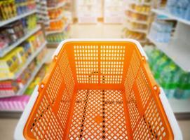 shopping cart with basket in supermarket or convenience store aisle photo