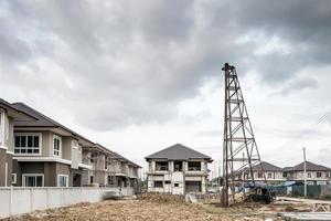 Residential new house building at construction site with clouds and blue sky photo