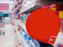 red discount sign display on supermarket shelves photo