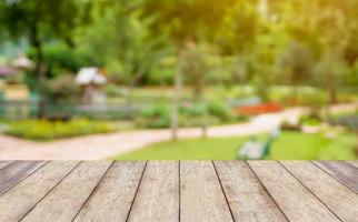 mesa de madera vacía con un fondo natural borroso del parque del jardín foto