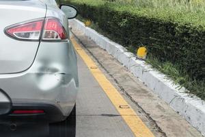 Backside of car has dented rear bumper damaged after accident photo