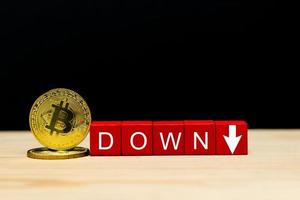 Market down of cryptocurrency.  Decreasing Value of Bitcoin. Bitcoin coins on black background photo