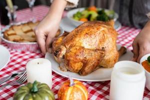 woman preparing turkey for thanksgiving dinner at home kitchen photo