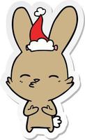 curious bunny sticker cartoon of a wearing santa hat vector