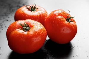 Fresh tomatoes with drops of water. Farm vegetables for vegan diet. photo