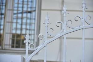 Iron fence with pins and lanterns in the city photo