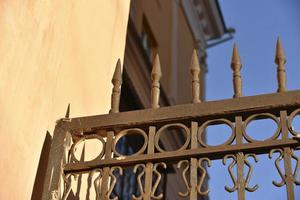Iron fence with pins and lanterns in the city photo