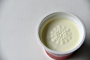 Jar with white sour cream on a white background photo