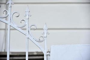 Iron fence with pins and lanterns in the city photo