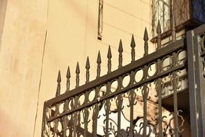 Iron fence with pins and lanterns in the city photo