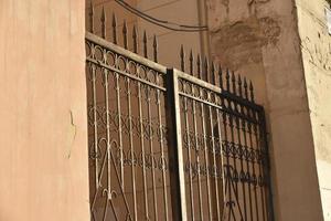 Iron fence with pins and lanterns in the city photo