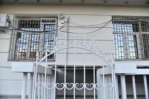 Iron fence with pins and lanterns in the city photo