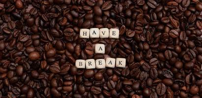 the words Have a break laid with wooden dices on a lot of coffee beans photo