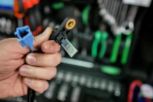 ABS sensor in the hands of an auto mechanic photo