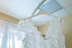 white boudoir lace dress on hanger photo